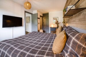 Megeve chalet bedroom bathroom en suite bed pillows shelf