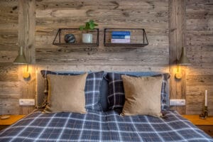 Megeve chalet bedroom bed shelf pillows lamps