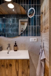 Megeve chalet bathroom recycled wood mirror blue tiles