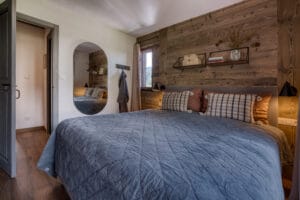 Megeve chalet bedroom bed pillows shelfs mirror