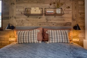 Megeve chalet bedroom bed pillows shelfs lamps